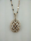 Diamond accented millgrain locket.