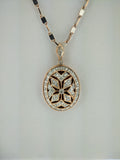 Diamond accented millgrain locket.